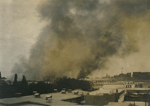 Smoke rises over Damascus Photograph